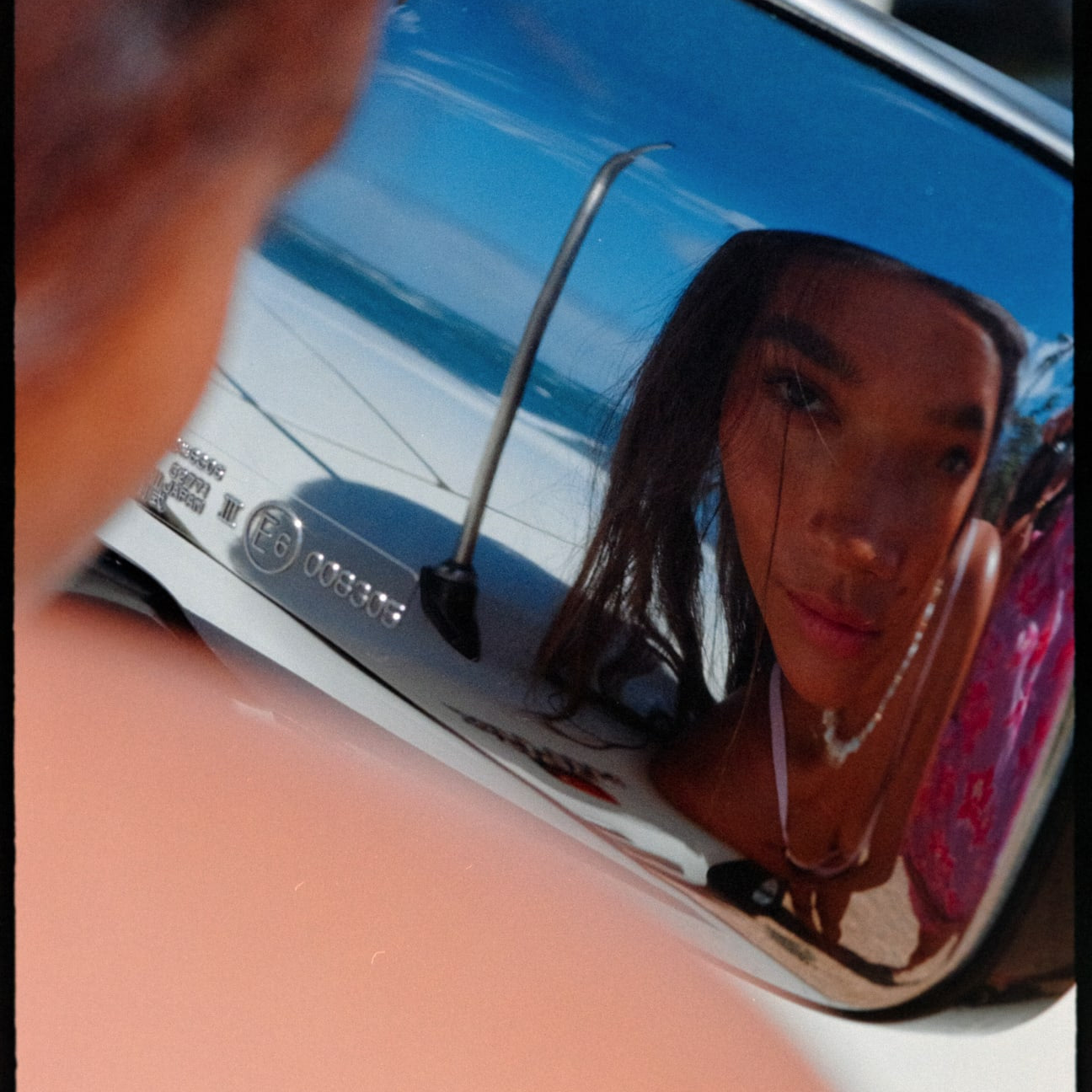 girl looking in car mirror