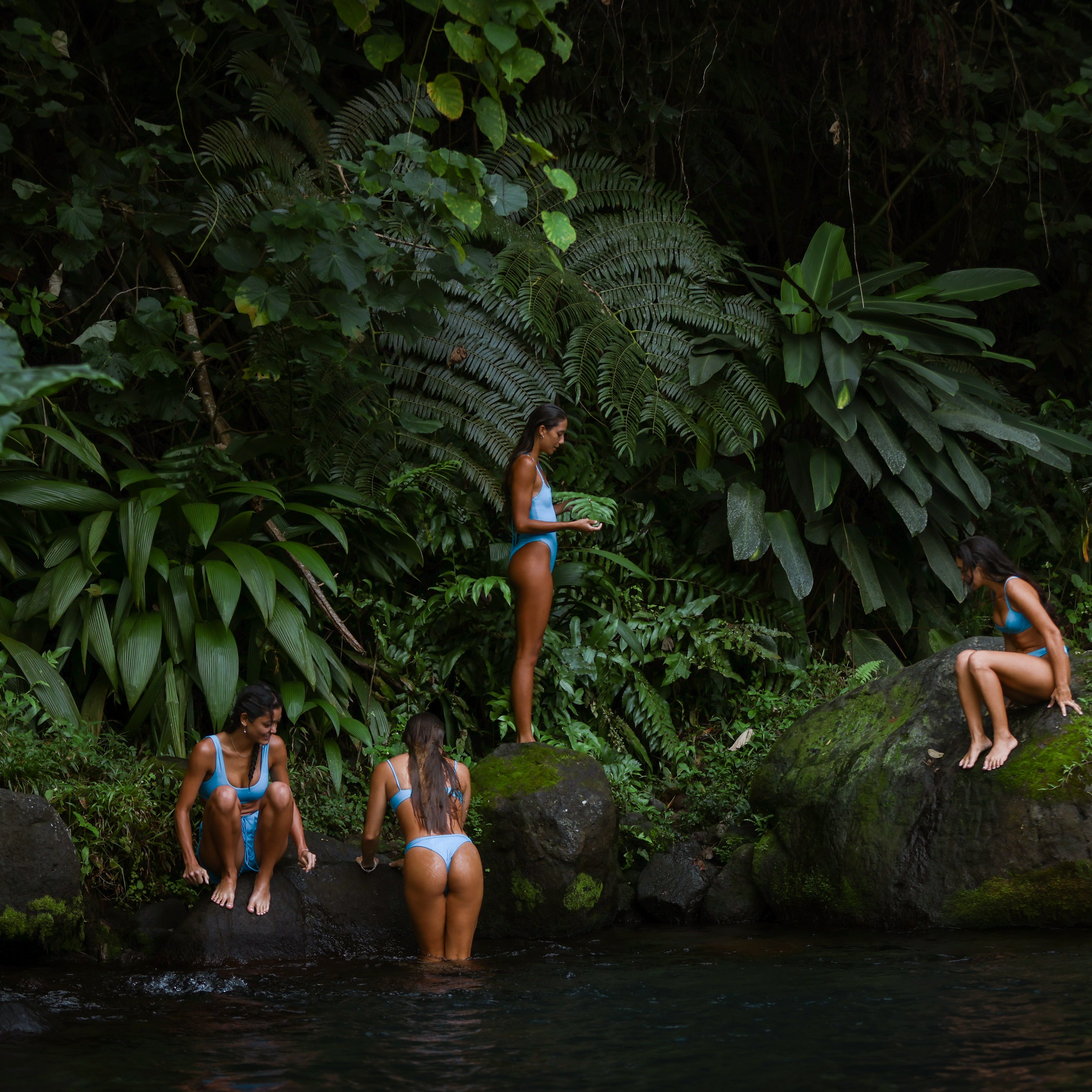 girls dipping in the fresh water spring in bikinis