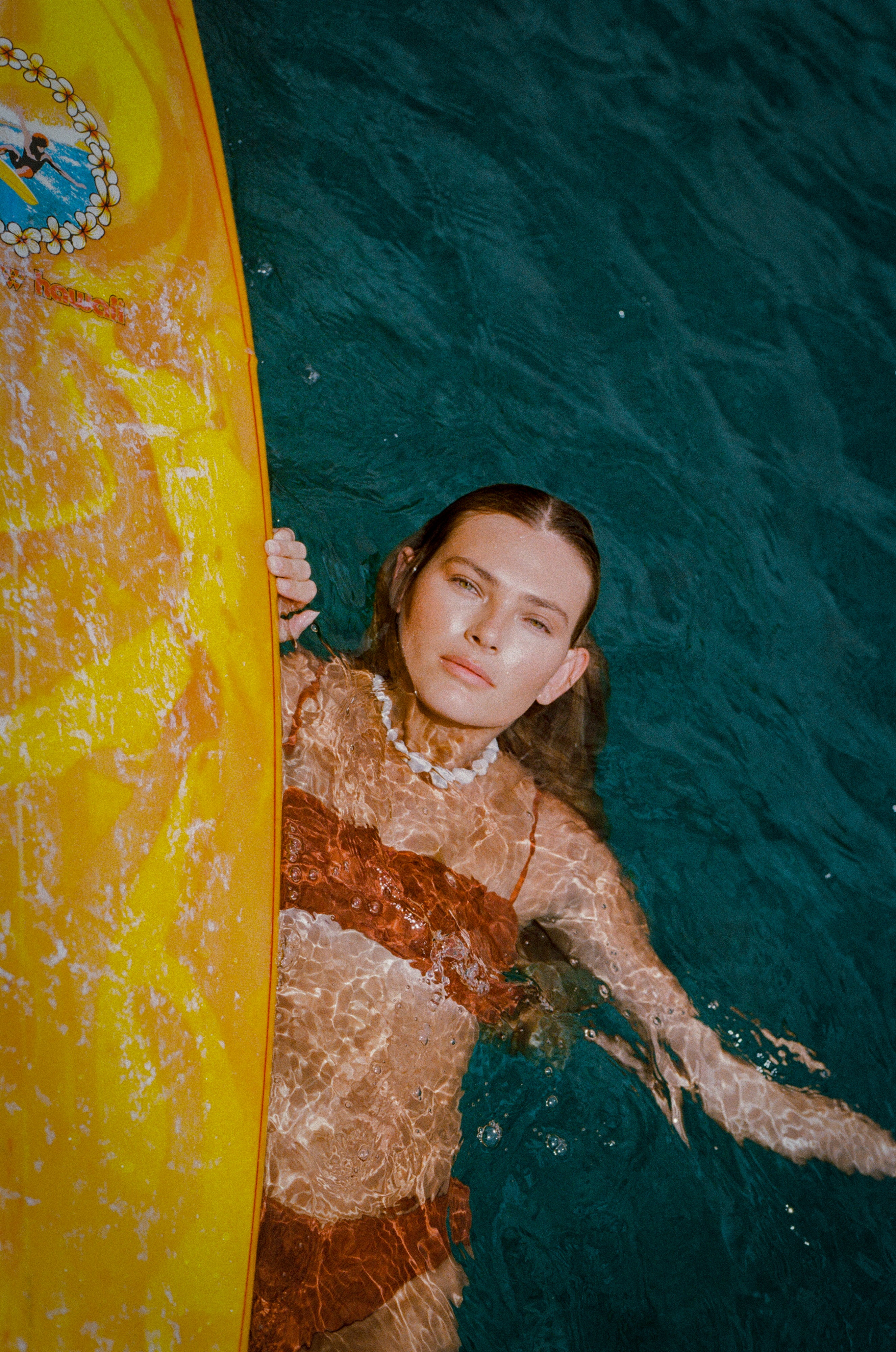 Girl with yellow surfboard