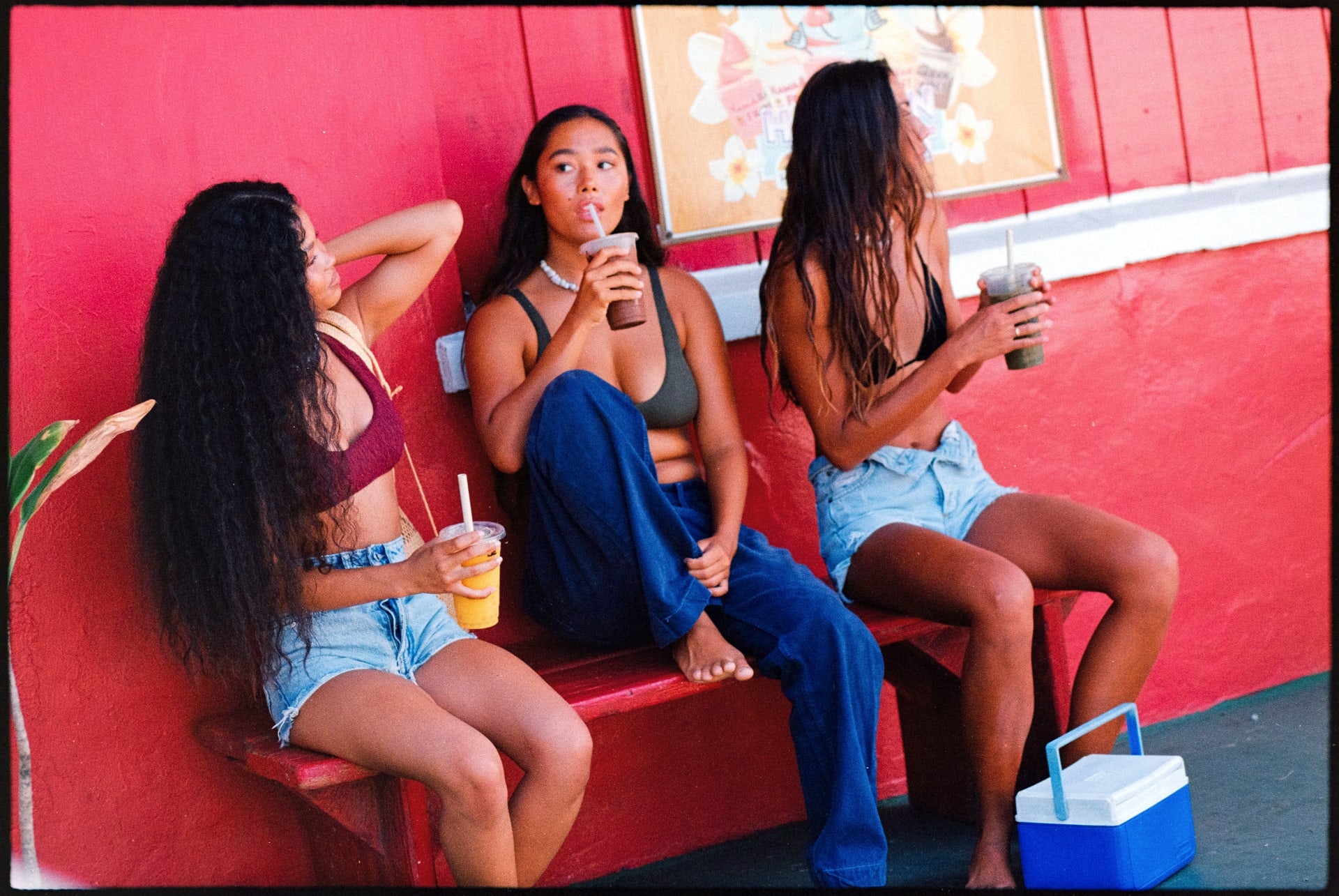 girls sitting drinking smoothies in bikinis and denim