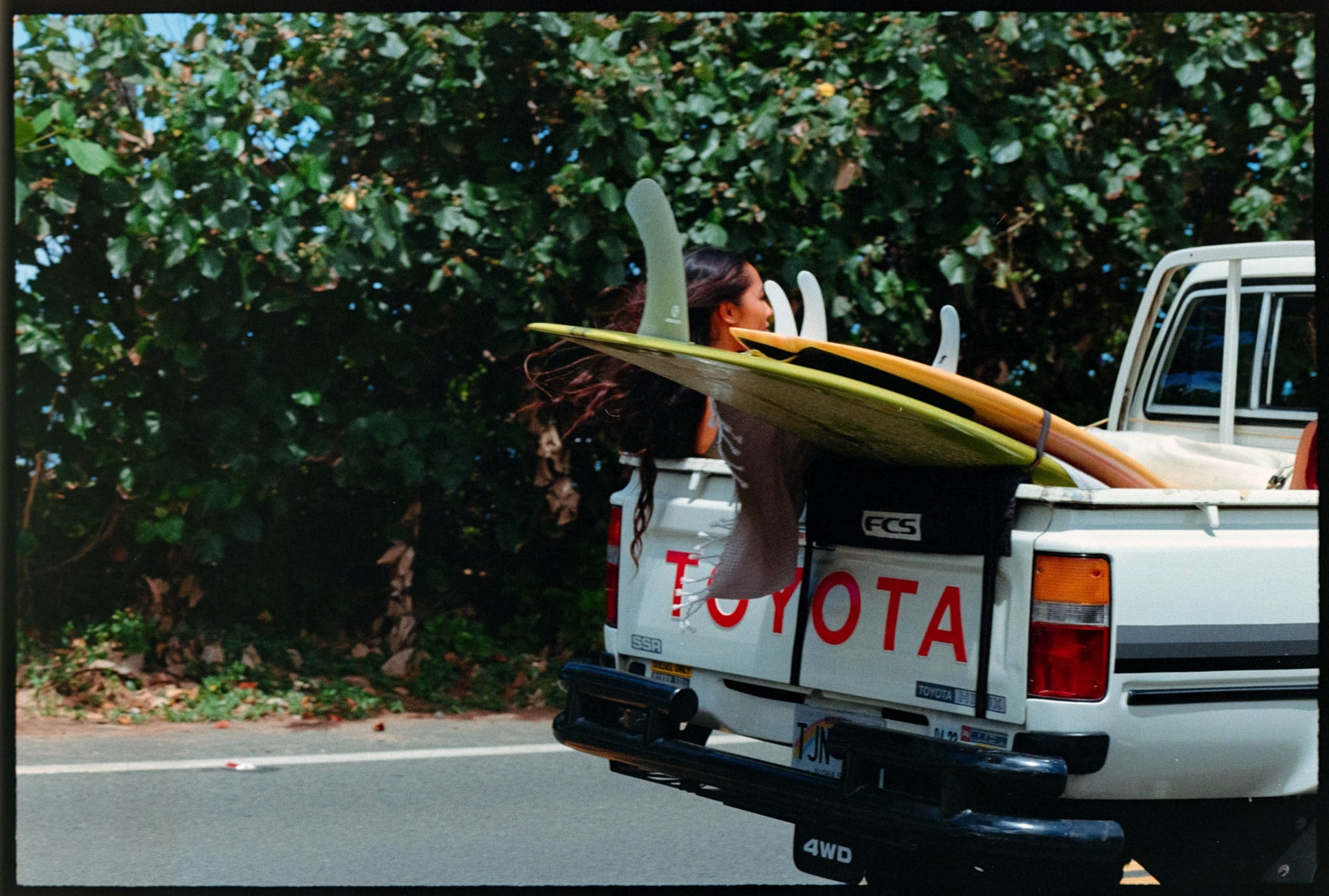 girl in back of truck with boards