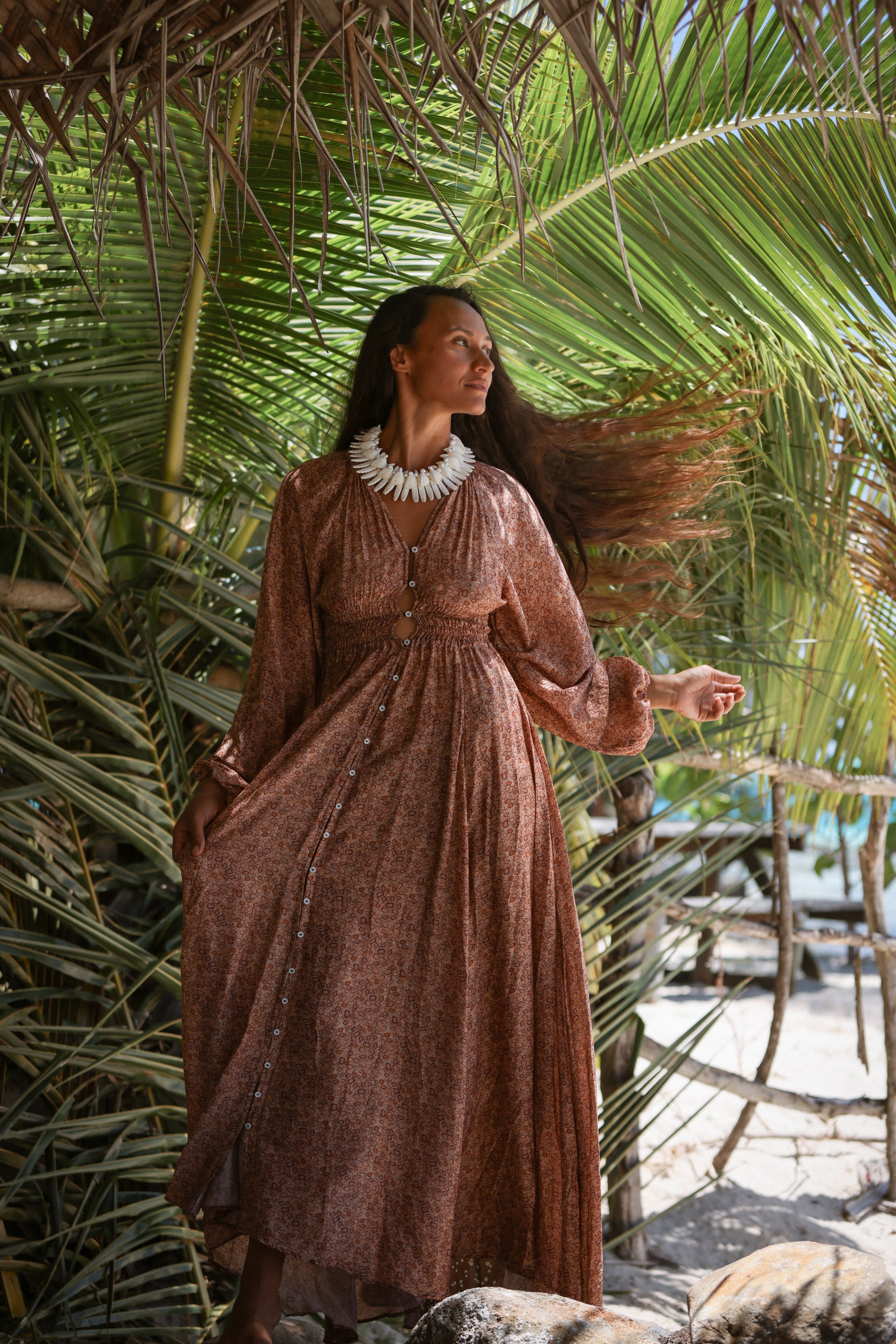 Girl wearing a brown dress with long sleeves