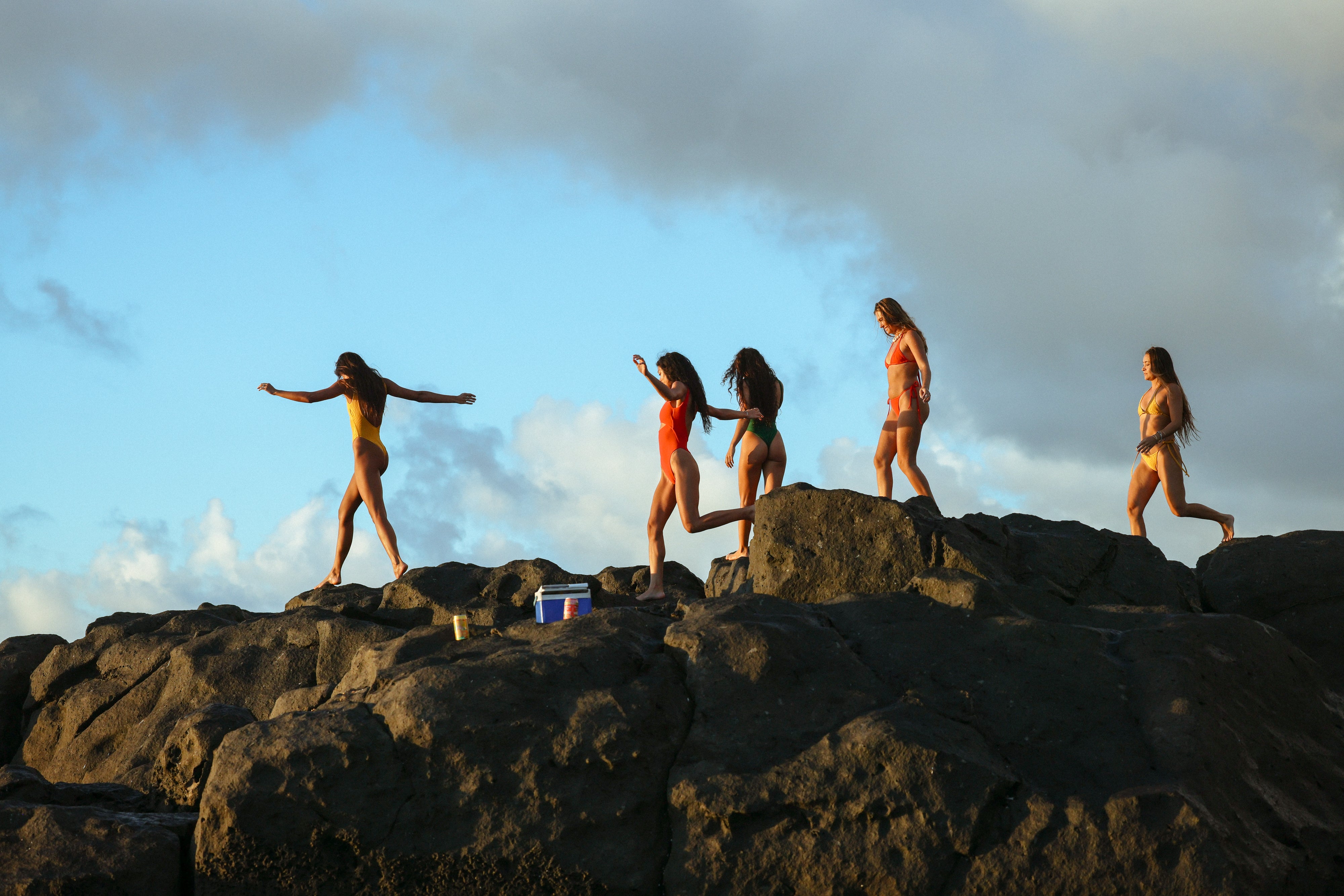 girls walking on rocks