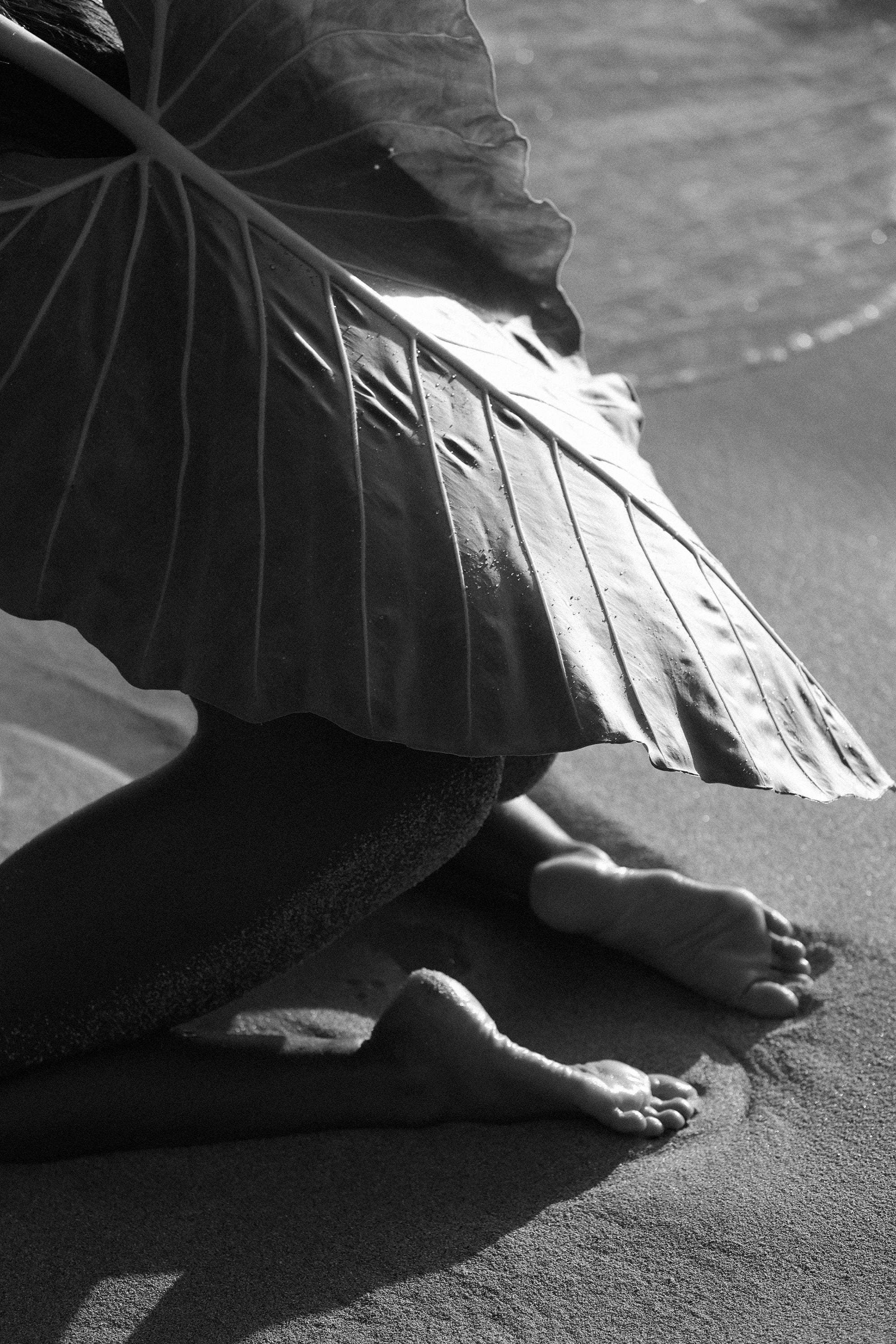 Girl covered in a leaf in black and white