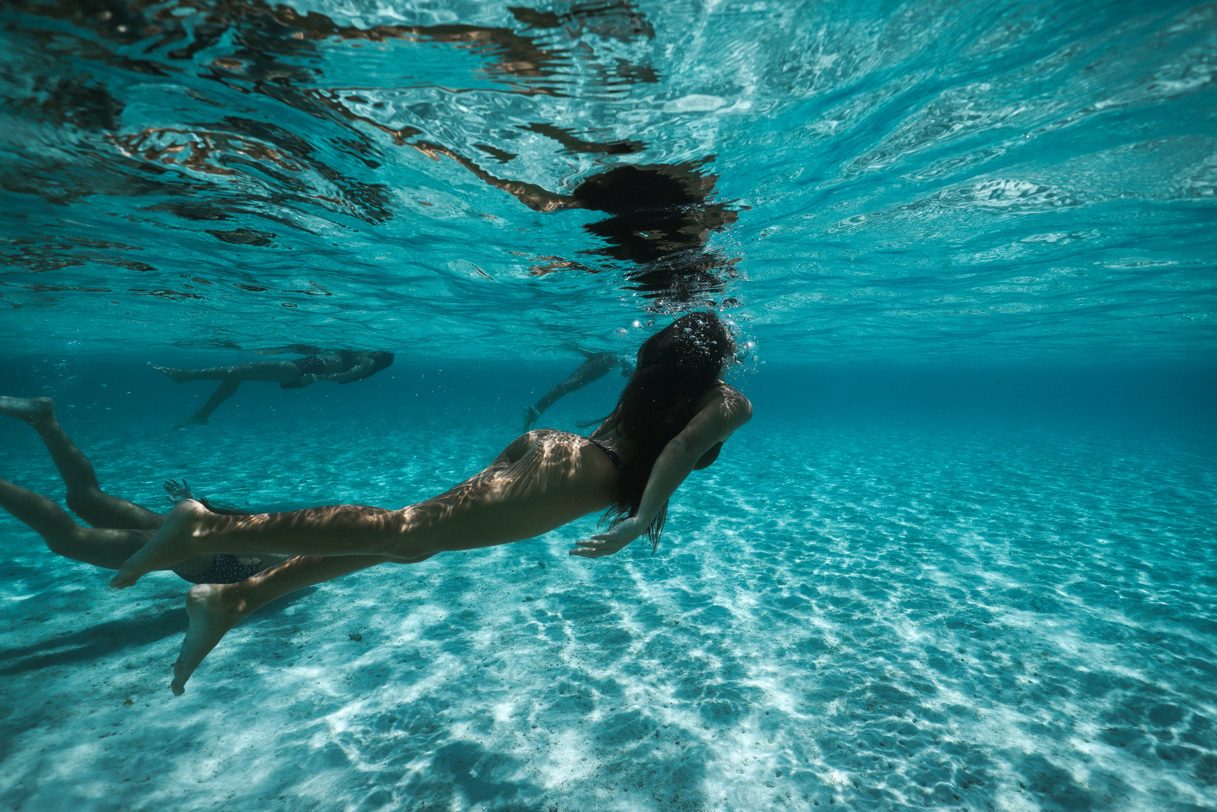 girls swimming underwater