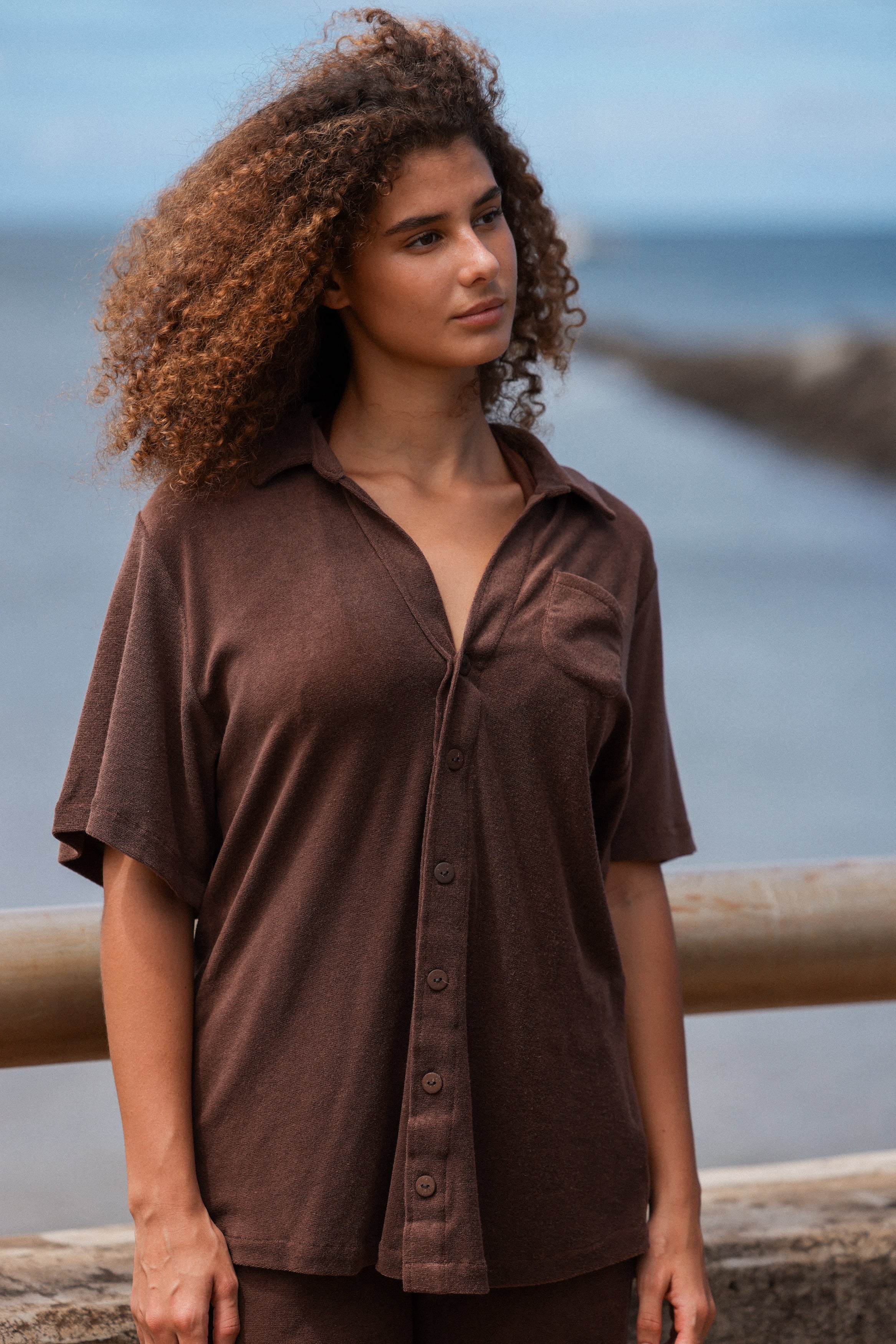 girl standing looking out at water in matching brown set in eco terry