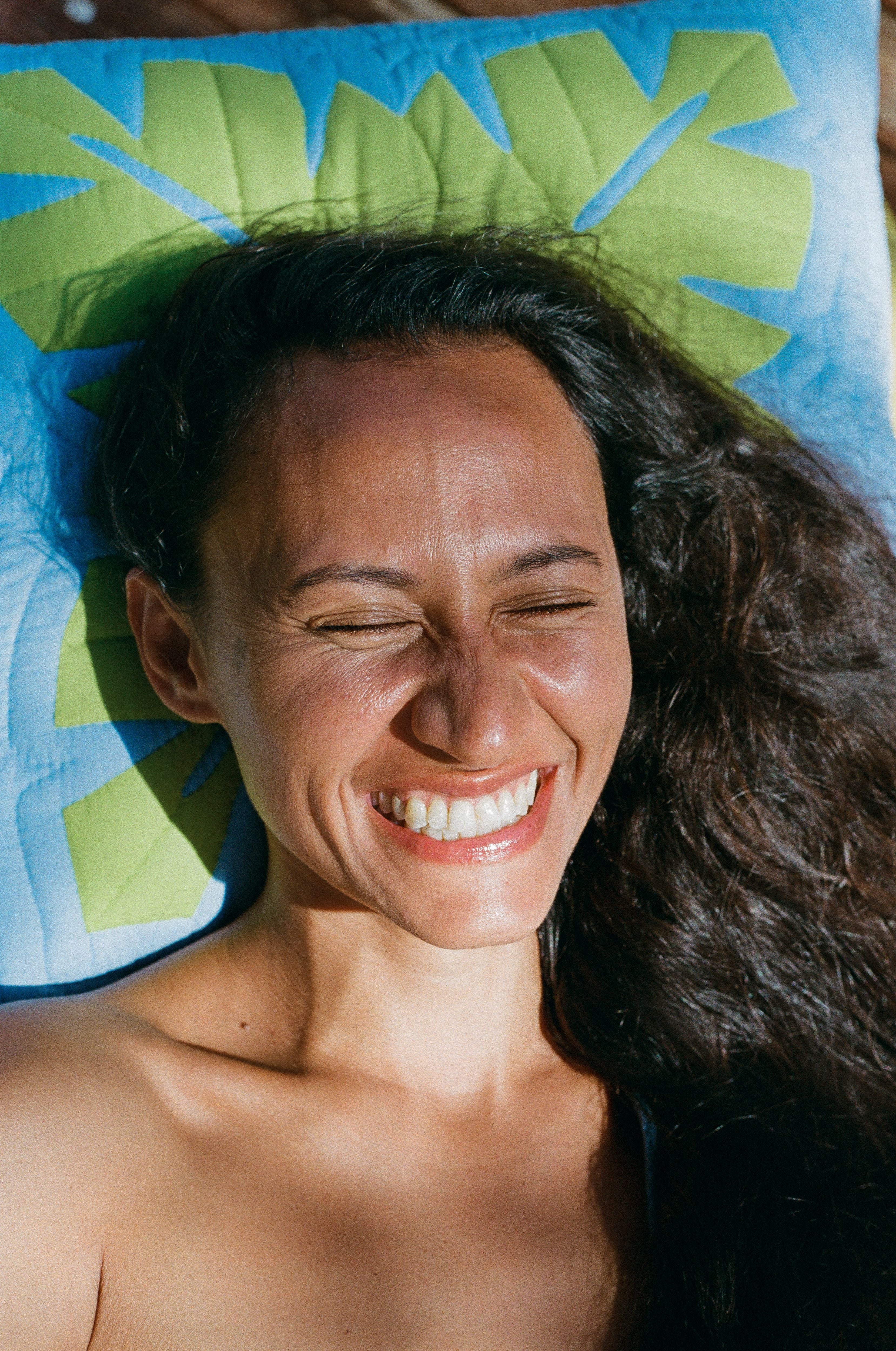 girl smiling on blanket 