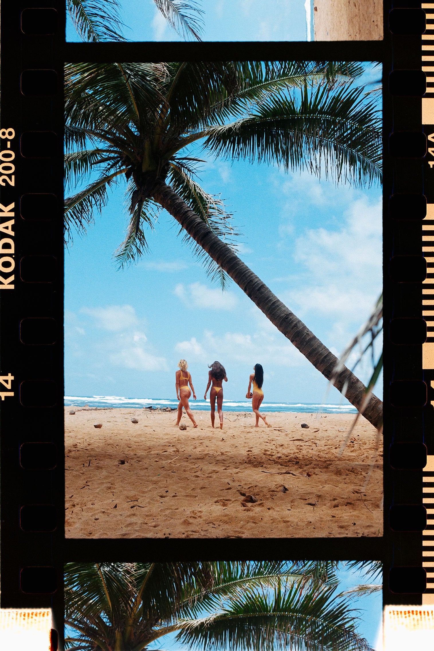 three girls in yellow on the beach.