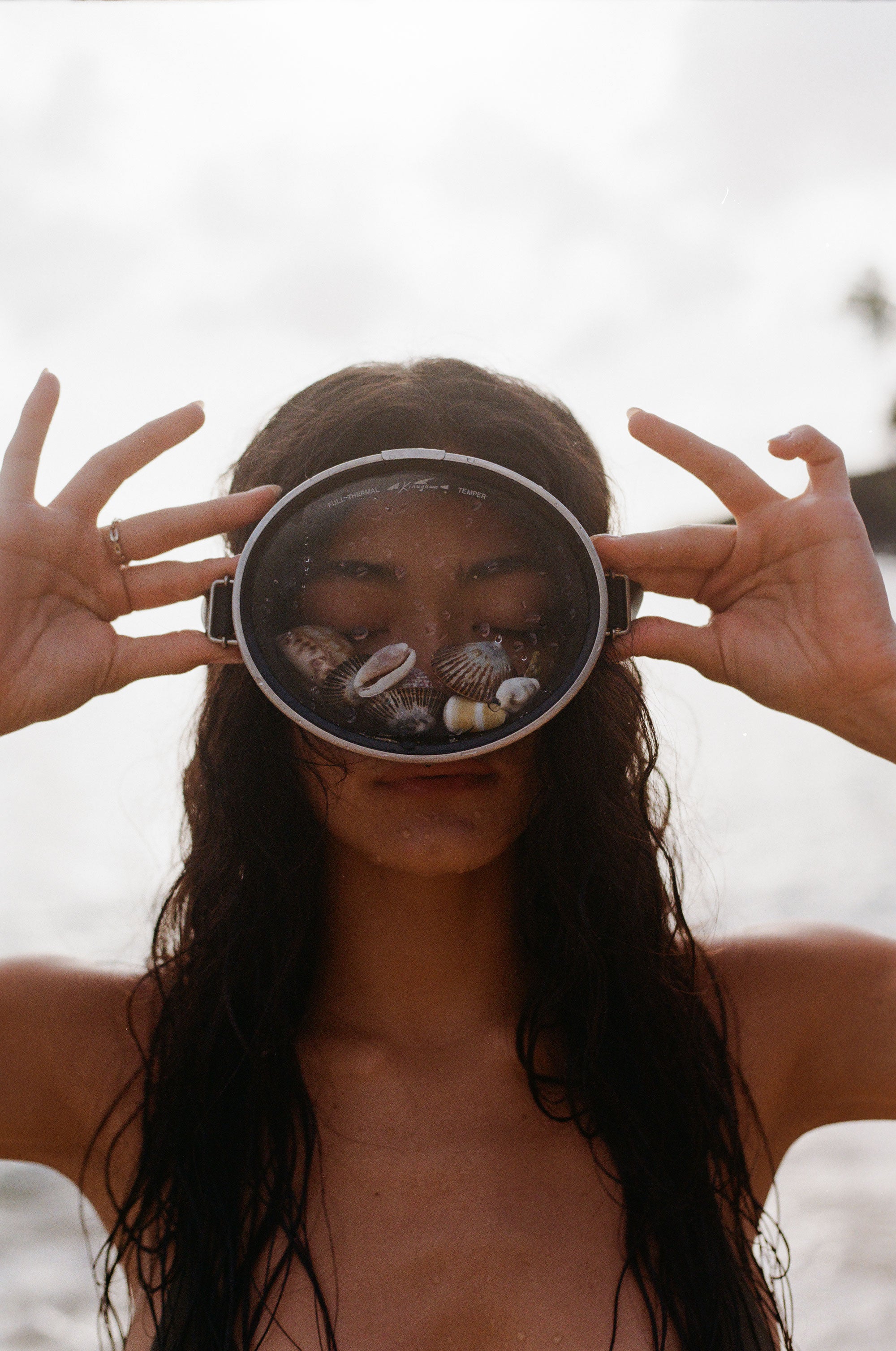 Girl wearing a snorkel with shells inside