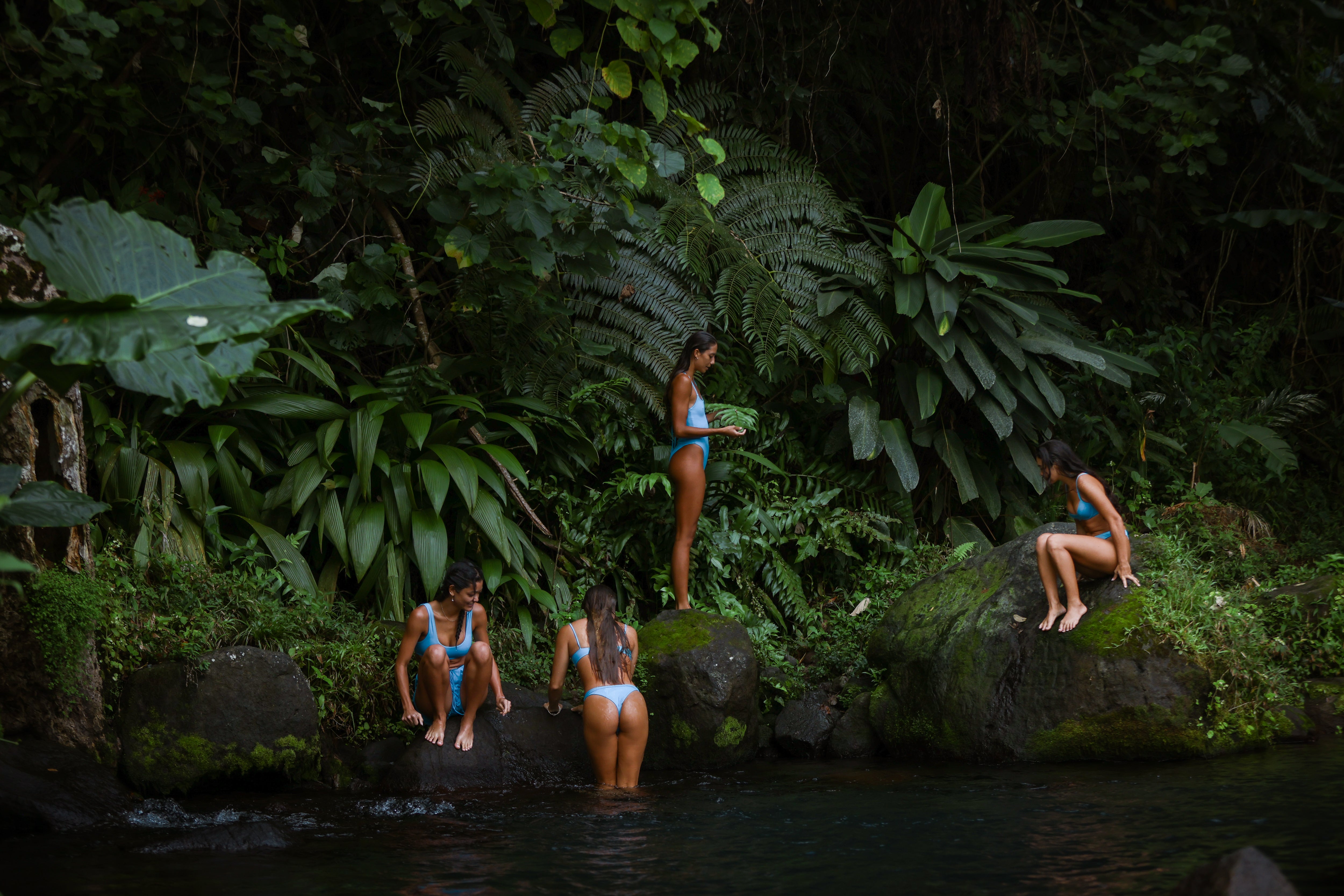 girls dipping in the fresh water spring in bikinis